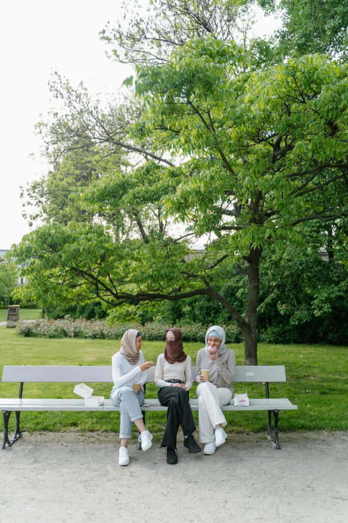 three women on a park bench