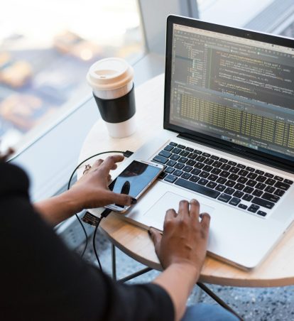 Woman updating the code on her computer.