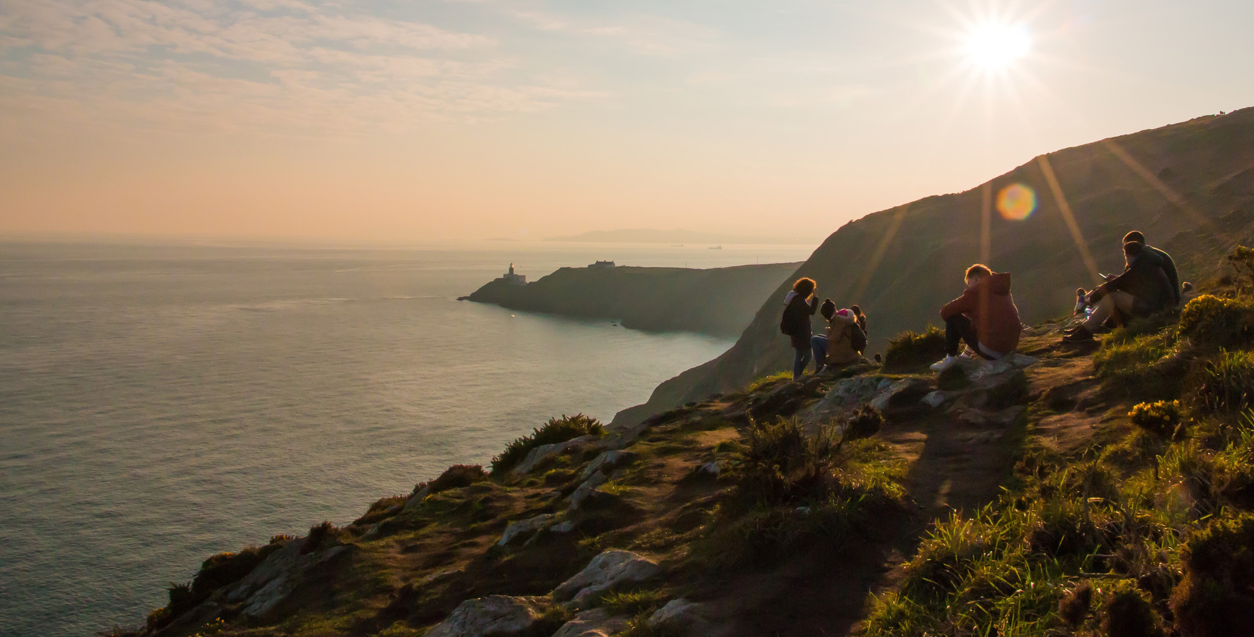 people enjoying time on cliffs looking out on the ocean