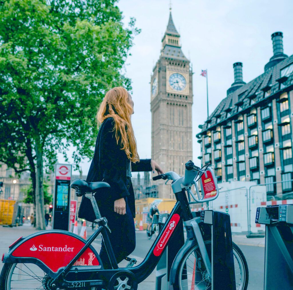 Woman with a bicycle in front of Big Ben