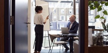 a man and women in a corporate office talking