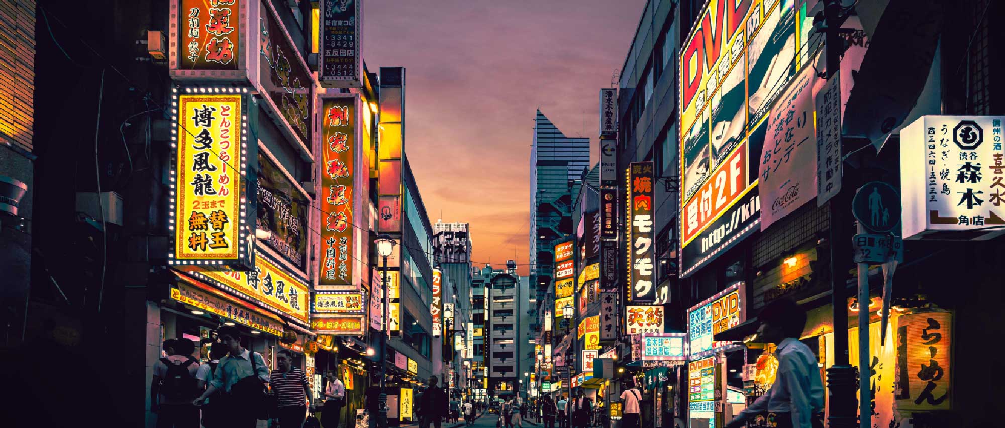 a busy Asian city street in the evening