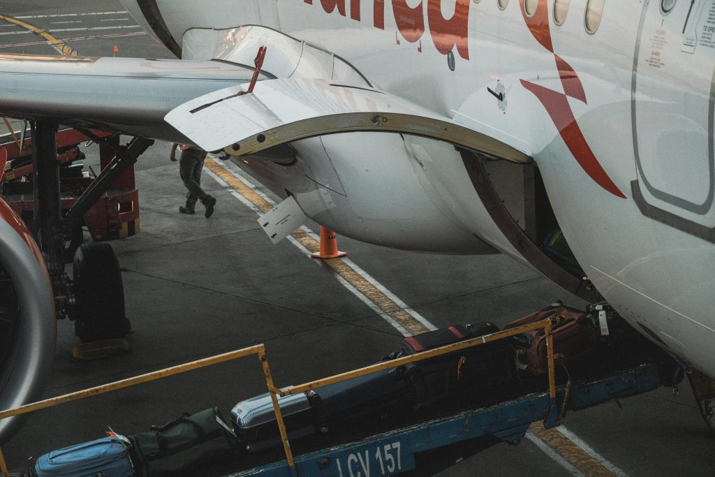 Suitcases being loaded on to an airplane