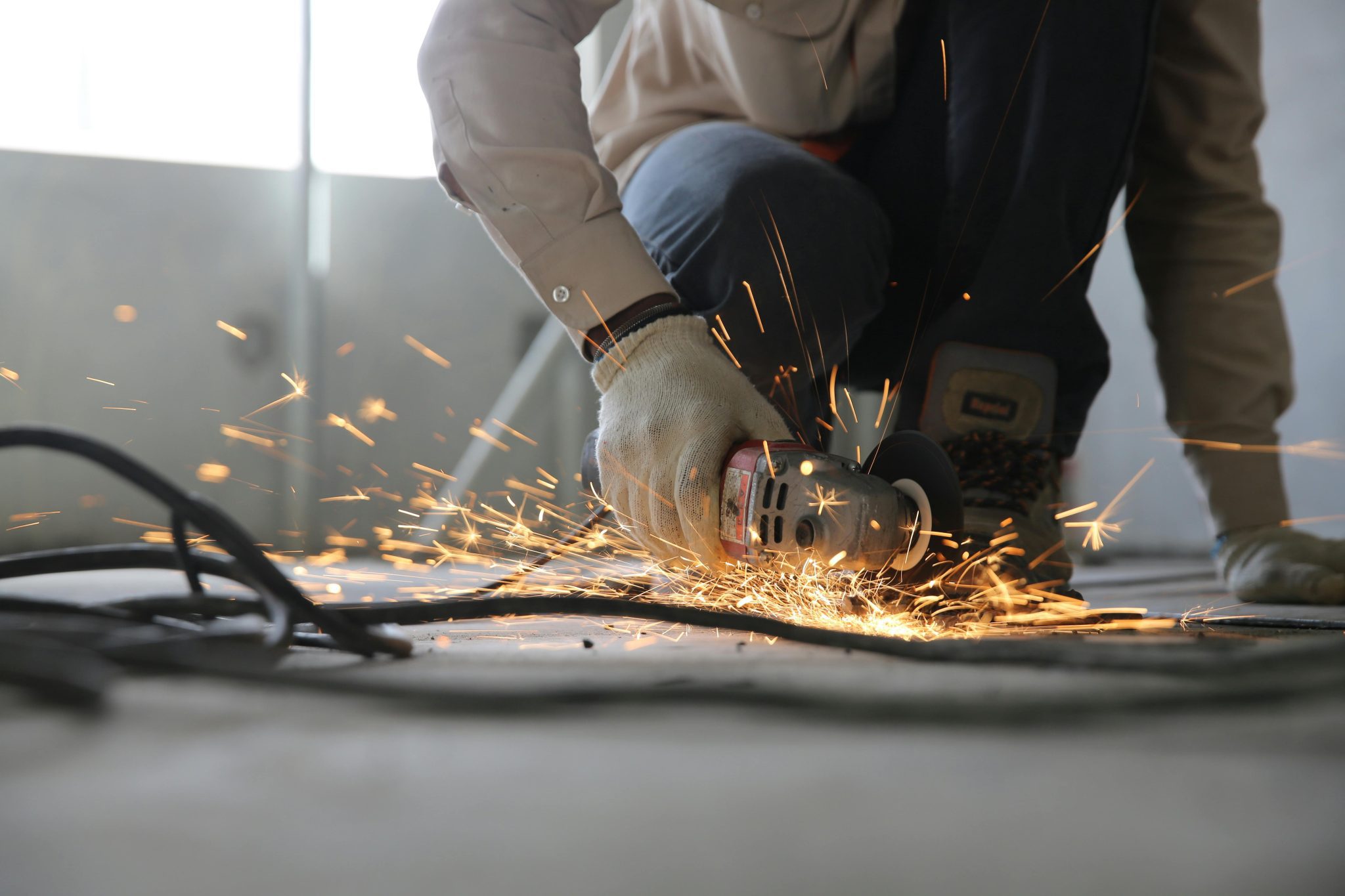 Person Grinding Metal.