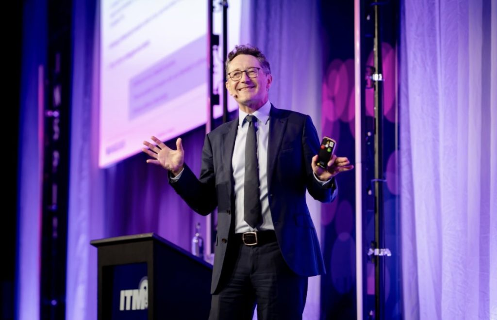 Man presenting on a stage.