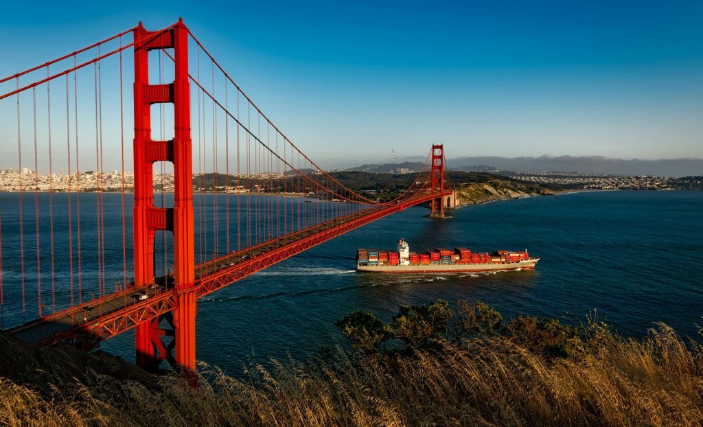 Cargo ship under Golden Gate bridge.