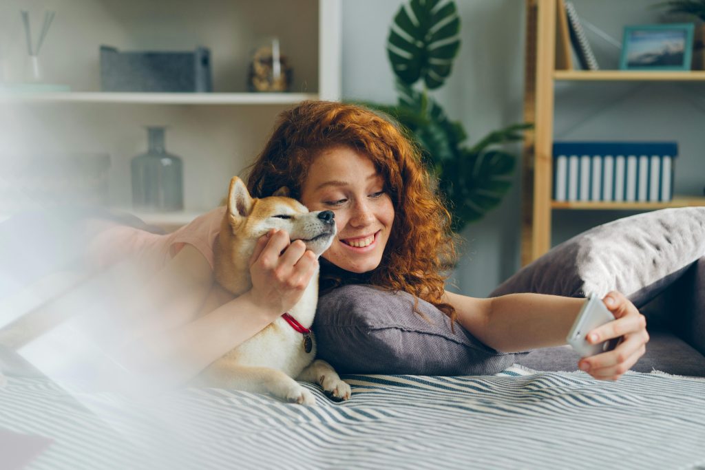 Woman taking a picture with her dog.