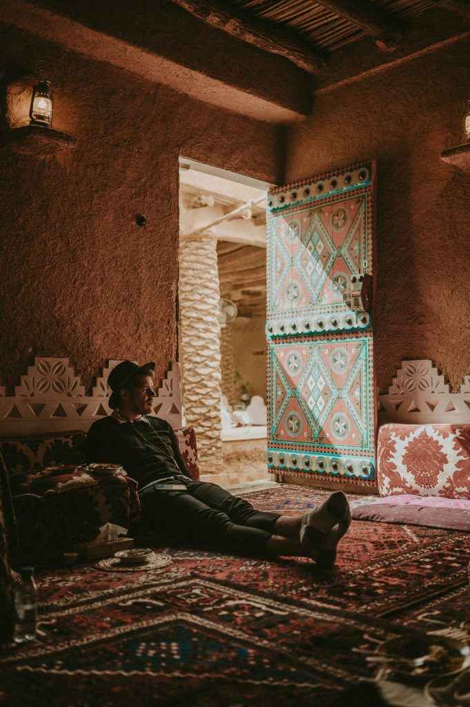 Man laying on a carpet.