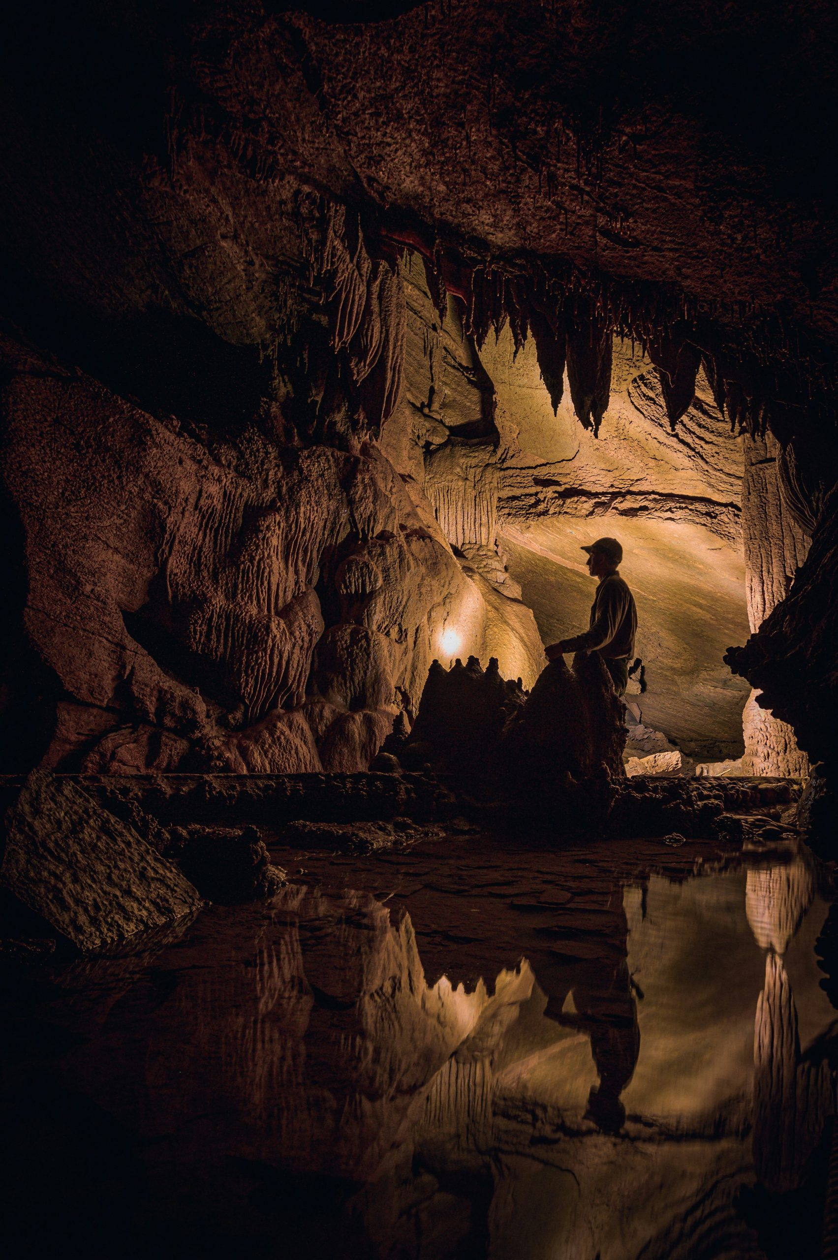 Man Standing In a Cave.