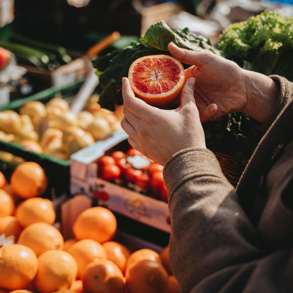 A Person Holding Freshly Cut Fruit.