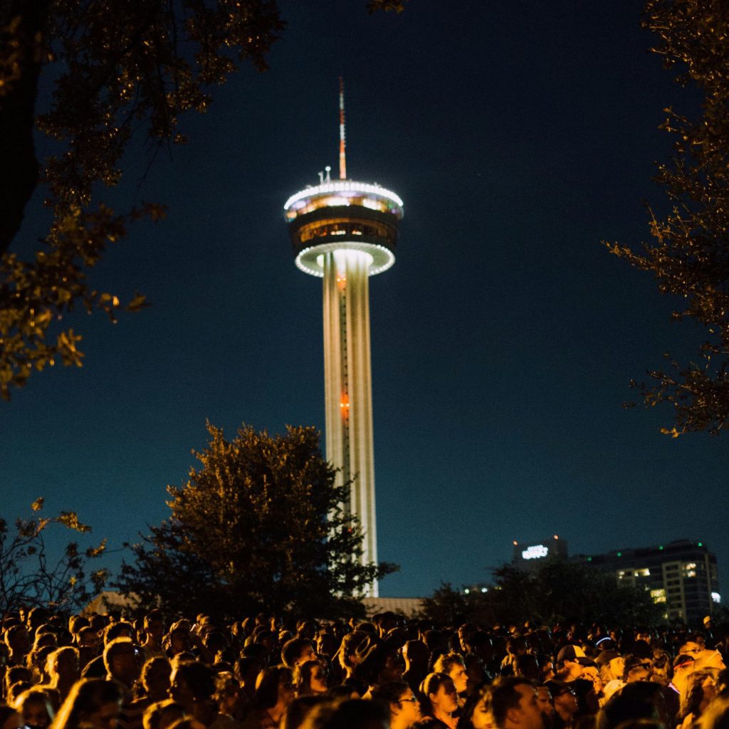 Crowd of People Standing Outside during Night Time