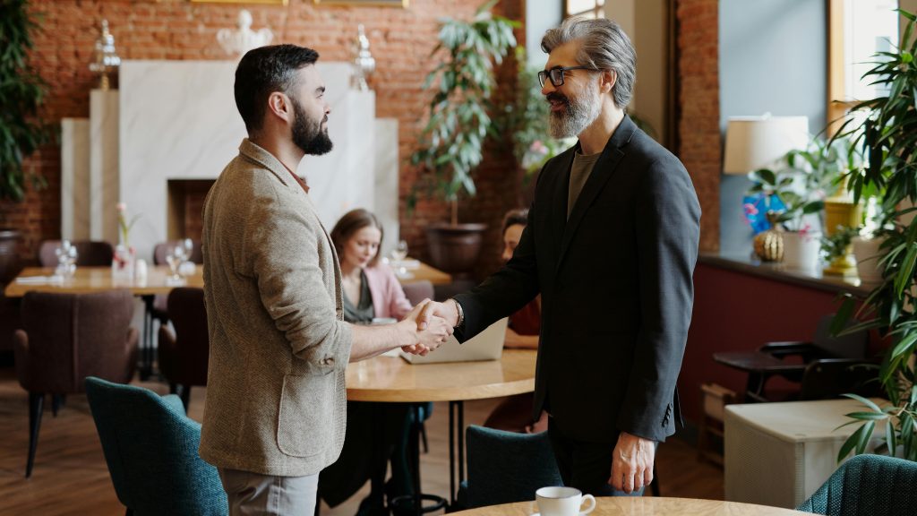 Bearded Men in Brown and Gray Suit Doing Handshake.