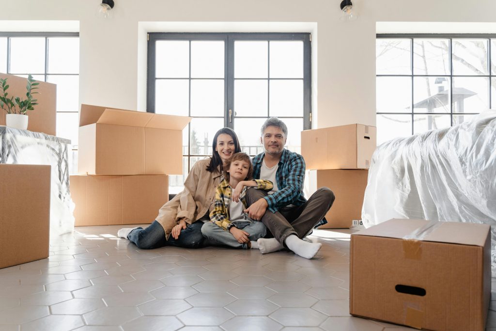 A Newly Moved Family Sitting on the Floor.