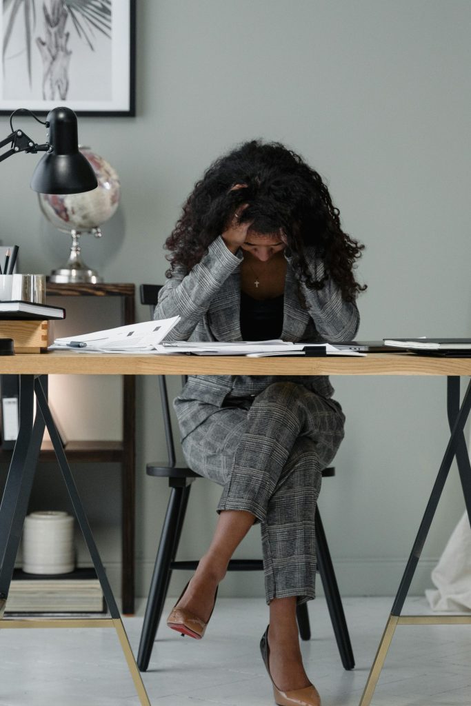A Woman Sitting at the Table Stressed.